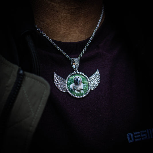 THE HIGH FLYER // WINGS PHOTO PENDANT is an essential piece to add to your collection to remember an OG in your life...5x Plated with Solid 18k Gold x Diamonds, this custom photo pendant has a breathtaking luster for a price that you simply can't find anywhere else. Stop Settling and Shop OG.